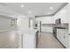 Spacious kitchen boasts an island, stainless steel appliances, gray backsplash, and ample counter space at 1925 Pepper Grass Dr, North Port, FL 34289