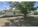 Backyard view featuring mature trees, providing shade and a natural aesthetic to the landscape at 2071 Linwood Ave, Spring Hill, FL 34608