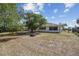 Lush backyard with shade trees surrounding the property, providing privacy at 2071 Linwood Ave, Spring Hill, FL 34608