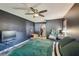 Bedroom featuring dark walls, a ceiling fan, and a green comforter on a bed at 2071 Linwood Ave, Spring Hill, FL 34608