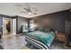 Bedroom showcasing dark walls, a ceiling fan, and a queen-sized bed with a striped comforter at 2071 Linwood Ave, Spring Hill, FL 34608