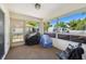 Enclosed patio with screened windows, outdoor furniture, and carpeted floor, perfect for relaxation at 2071 Linwood Ave, Spring Hill, FL 34608