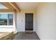 Front door with a black security screen and a cozy 'Home Sweet Home' welcome mat at 2071 Linwood Ave, Spring Hill, FL 34608