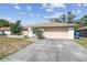 Single-story home featuring an attached garage, concrete driveway and neutral color palette at 2071 Linwood Ave, Spring Hill, FL 34608