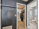 Hallway showing a closet and a door leading to a bathroom with a glass-enclosed shower at 2071 Linwood Ave, Spring Hill, FL 34608