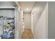 Hallway with neutral paint, tile floors, and access to multiple rooms with storage solutions at 2071 Linwood Ave, Spring Hill, FL 34608
