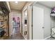 Hallway leading to the bathroom and bedroom, with storage and gray painted walls at 2071 Linwood Ave, Spring Hill, FL 34608