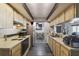 Kitchen boasts neutral wood cabinets, tile flooring, and appliances at 2071 Linwood Ave, Spring Hill, FL 34608