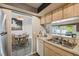 Kitchen pass-through offers view to dining area, tile floors, and natural light at 2071 Linwood Ave, Spring Hill, FL 34608