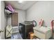 Laundry room with modern washer and dryer, utility sink, and storage rack at 2071 Linwood Ave, Spring Hill, FL 34608