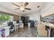 Bright living room with tile floors, a fan, and space for work-from-home setup at 2071 Linwood Ave, Spring Hill, FL 34608