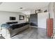 Open living room boasting tile flooring, a couch, and wall-mounted TV, creating a welcoming space at 2071 Linwood Ave, Spring Hill, FL 34608