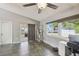 Inviting living room with fan, tile flooring, and sliding glass doors to sunroom at 2071 Linwood Ave, Spring Hill, FL 34608
