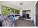 Bright sunroom with screened windows and sliding door offers comfortable seating and natural light at 2071 Linwood Ave, Spring Hill, FL 34608