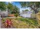 Expansive backyard featuring lush green grass, mature trees, and a charming, detached garage at 2134 6Th N Ave, St Petersburg, FL 33713