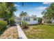Charming single-story home with tidy landscaping and bright blue window shutters at 2134 6Th N Ave, St Petersburg, FL 33713