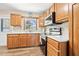 Well-lit kitchen featuring oak cabinetry, tiled floors, and modern oven at 2134 6Th N Ave, St Petersburg, FL 33713