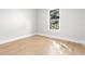 Bright bedroom featuring hardwood floors and a window overlooking lush scenery at 220 Hesperides N St, Tampa, FL 33609