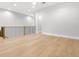Open loft area with hardwood floors, railing, and abundant natural light at 220 Hesperides N St, Tampa, FL 33609