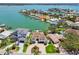 Stunning aerial view of a waterfront neighborhood with luxurious homes, private docks, and boats at 2233 Donato Dr, Belleair Beach, FL 33786