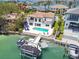 Stunning waterfront home with a private pool, boat dock, and lush landscaping, offering luxurious living at 2233 Donato Dr, Belleair Beach, FL 33786