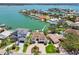 Beautiful waterfront home featuring a private dock, a pool, and manicured grounds in a sought-after community at 2233 Donato Dr, Belleair Beach, FL 33786