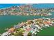 A picturesque aerial view showcasing an island community with waterfront homes and stunning city views at 2233 Donato Dr, Belleair Beach, FL 33786
