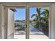 Balcony view featuring views of the water, docks, boats, blue sky, and a palm tree at 2233 Donato Dr, Belleair Beach, FL 33786