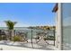 Balcony view overlooking water with palm trees and other tropical plants at 2233 Donato Dr, Belleair Beach, FL 33786