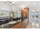 The bathroom boasts dual sinks, a separate shower and tub, with access to a private balcony at 2233 Donato Dr, Belleair Beach, FL 33786