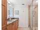 A cozy bathroom features granite counters, a sink, storage, and a walk-in shower at 2233 Donato Dr, Belleair Beach, FL 33786