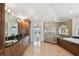 The luxurious bathroom offers dual sinks, a glass shower, a soaking tub, and access to a private balcony at 2233 Donato Dr, Belleair Beach, FL 33786