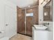 Bathroom with updated features, including walk-in shower with glass door and tiled walls at 2233 Donato Dr, Belleair Beach, FL 33786
