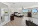 Spacious, light-filled bedroom with hard floors, fan, bench, desk, and windows overlooking the neighborhood at 2233 Donato Dr, Belleair Beach, FL 33786