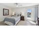 A comfortable bedroom features a ceiling fan, a soft bed, and access to a balcony at 2233 Donato Dr, Belleair Beach, FL 33786