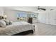 Bedroom with natural light, featuring two windows, light colored flooring, and a ceiling fan at 2233 Donato Dr, Belleair Beach, FL 33786
