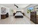 Bright bedroom featuring dual windows, a ceiling fan, and classic wooden furniture at 2233 Donato Dr, Belleair Beach, FL 33786