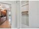 Walk-in closet with mirrored doors, showcasing functional storage and seamless access to the Primary suite at 2233 Donato Dr, Belleair Beach, FL 33786