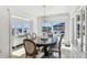 Dining room with chandelier and large window looking out to the pool and waterfront at 2233 Donato Dr, Belleair Beach, FL 33786
