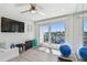 The bright exercise room is equipped with a ceiling fan and sliding glass doors to the balcony at 2233 Donato Dr, Belleair Beach, FL 33786