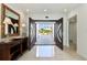 Grand foyer featuring double doors, marble floors, and a view of the property beyond at 2233 Donato Dr, Belleair Beach, FL 33786