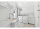 Laundry room boasts front load washer and dryer, sink, and plenty of storage at 2233 Donato Dr, Belleair Beach, FL 33786