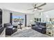 Comfortable living room with large windows and views, featuring comfortable seating and ceiling fan at 2233 Donato Dr, Belleair Beach, FL 33786