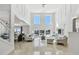Expansive living room boasting high ceilings, large windows, and an open view to the pool and waterway at 2233 Donato Dr, Belleair Beach, FL 33786