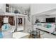Bright living room featuring high ceilings, white furniture, and a clear view to the second-floor loft at 2233 Donato Dr, Belleair Beach, FL 33786
