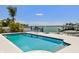 Beautiful backyard with a pool, dock, and outdoor seating at 2233 Donato Dr, Belleair Beach, FL 33786