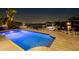 Inviting pool featuring built-in steps and a water view, illuminated at night at 2233 Donato Dr, Belleair Beach, FL 33786