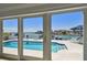 Waterfront pool and patio area visible through the home's sliding glass doors, providing access to waterfront fun at 2233 Donato Dr, Belleair Beach, FL 33786