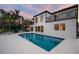 Beautiful backyard pool and patio area, perfect for entertaining with a view of the home's balconies at 2233 Donato Dr, Belleair Beach, FL 33786