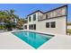 Beautiful backyard with a pool, umbrellas, and outdoor seating at 2233 Donato Dr, Belleair Beach, FL 33786